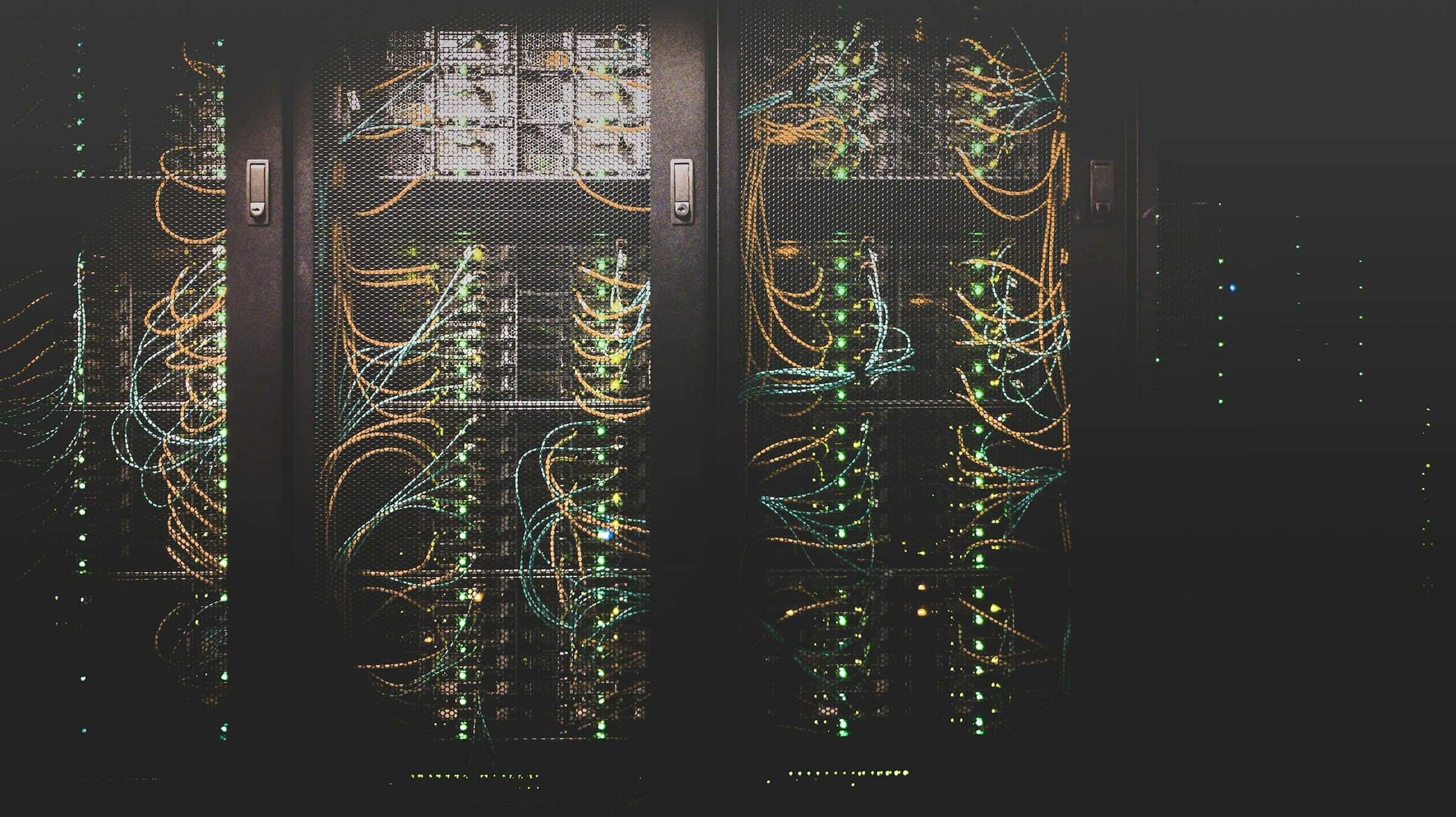 Server racks with status lights in a data centre aisle